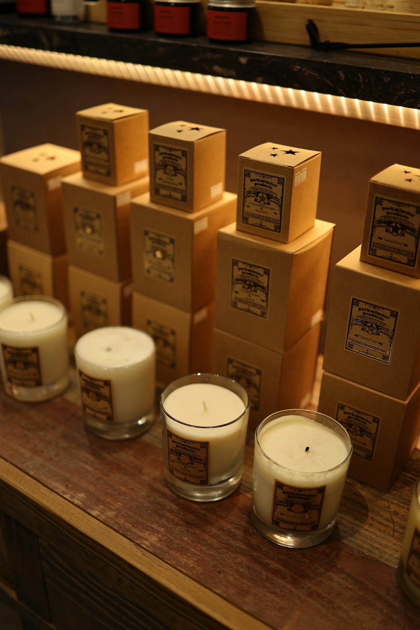 Candles and boxed products displayed in a shop.